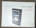 Brookstone: Tiny Tunes - Micro MP3 Player Black Blank Screen Used. Price: $19.99.
